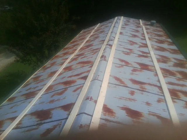 Rusted metal roof panels with new wood purlins before replacement — Storm Damage Roof Repair in Somonauk by Roofing Brothers