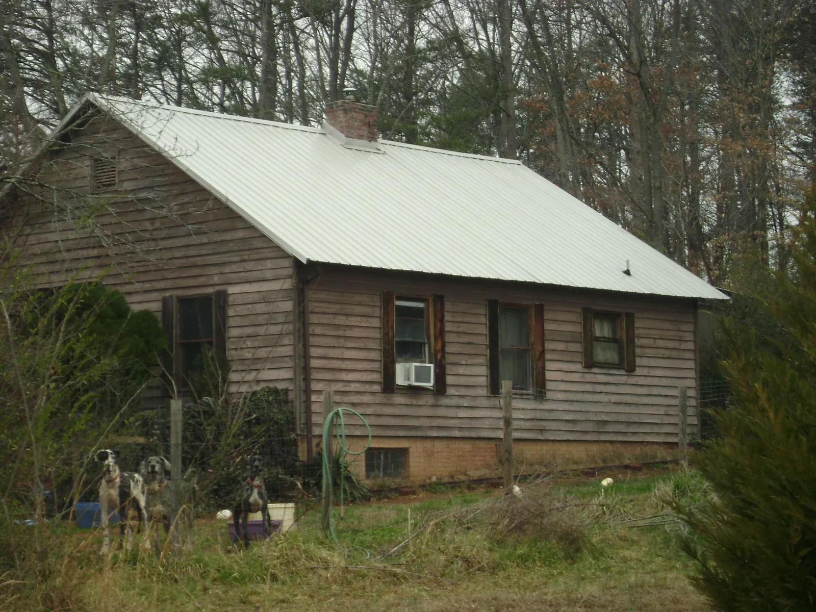 White metal roof on an old wood sided farmhouse, from a Metal Roof Installation job in Somonauk